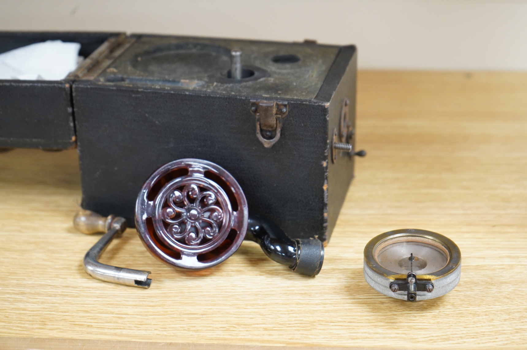A late 19th century miniature portable gramophone, with a celluloid speaker, possibly Kammer & Reinhardt, 11 x 16 x 14.5cm